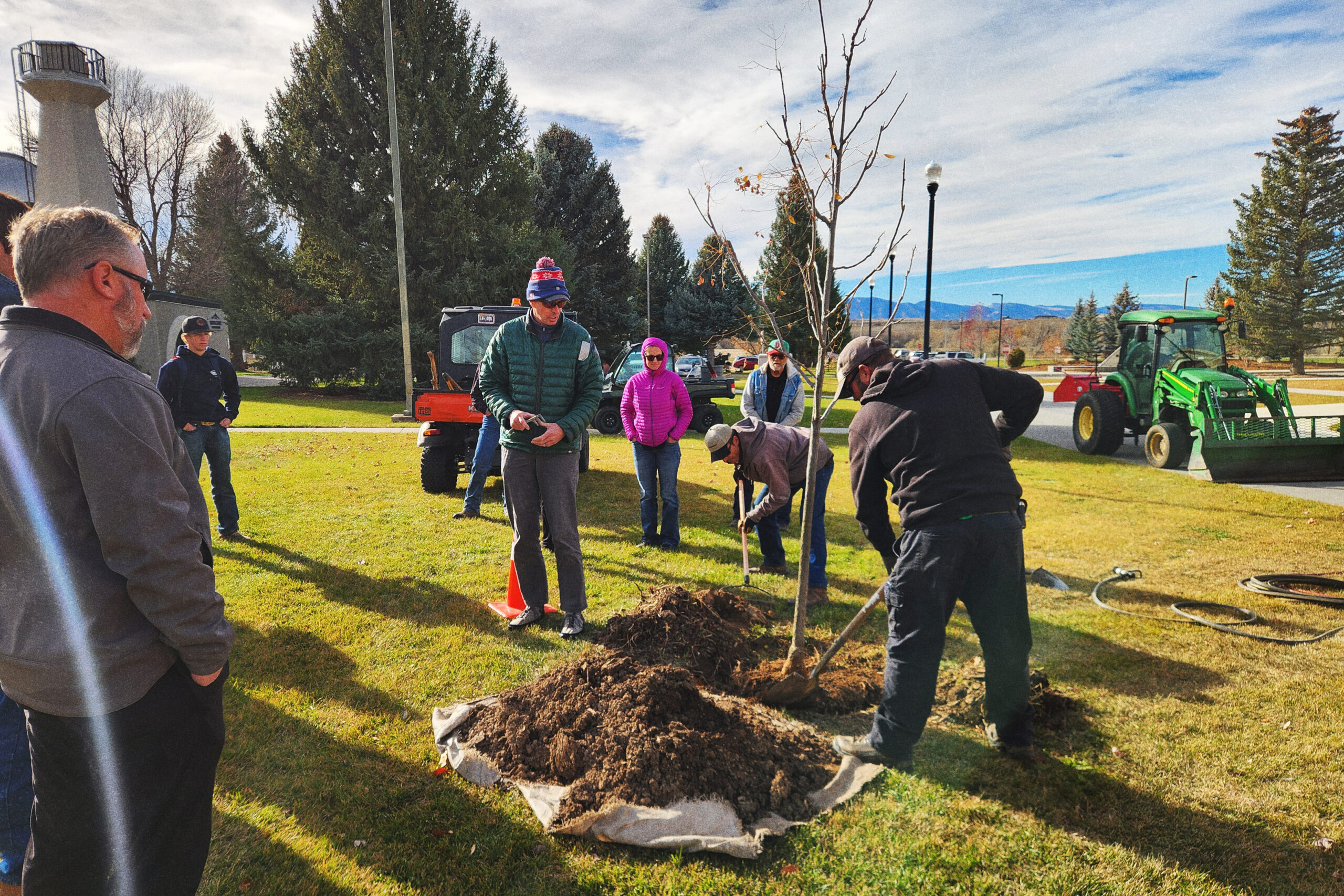 2025ArborDaySheridan A group of people planting a tree in a park