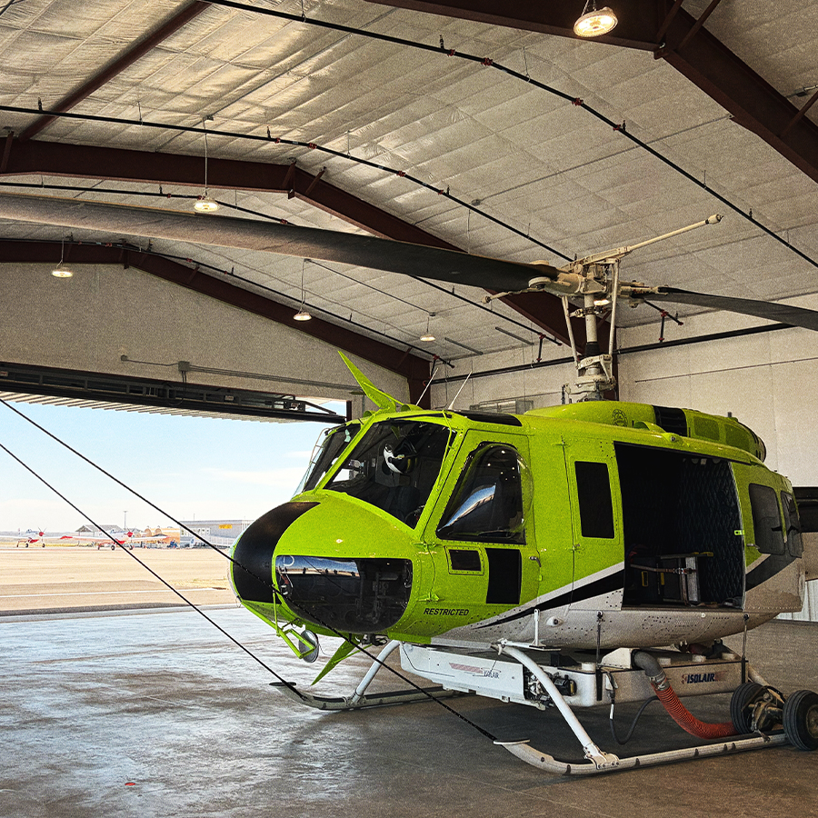 Helibase2 A lime-green helicopter sits at rest inside a helibase.