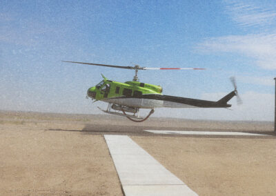 A helicopter is captured at takeoff on a runway.